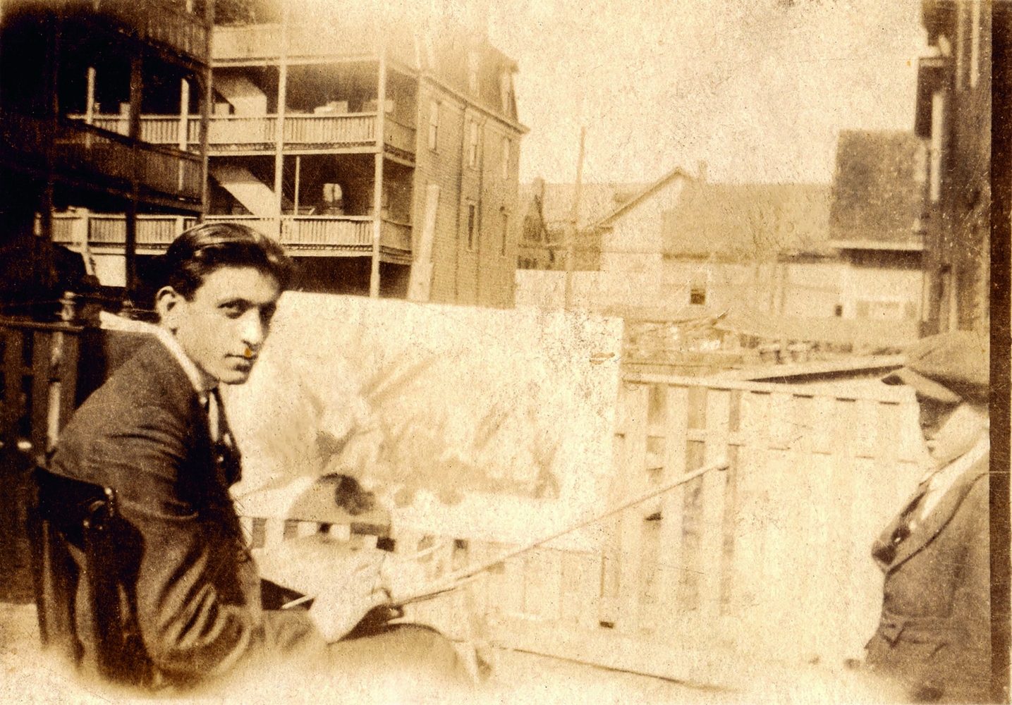 Gorky painting at his sister Akabi&#039;s house on Dexter Avenue in Watertown, MA, c. 1922. Unknown photographer. Gift of Gail Sarkissian.